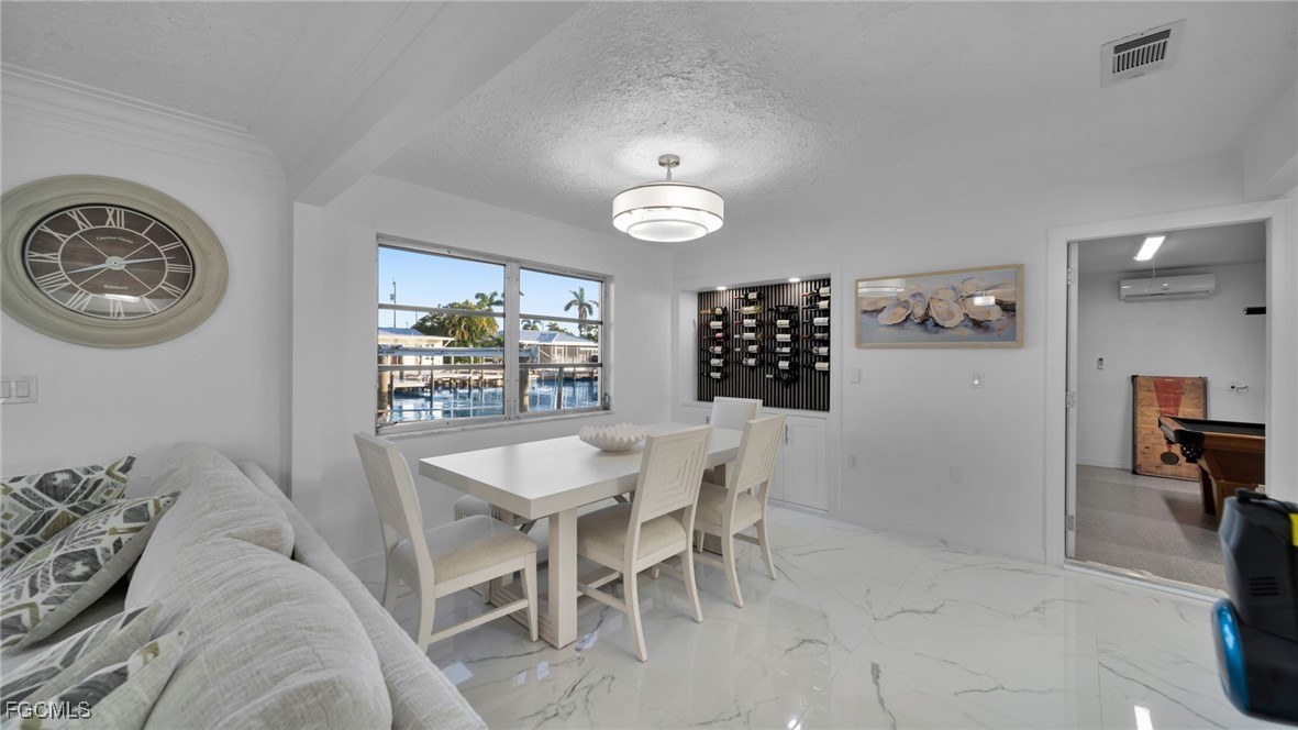 2758 Bruce Street Matlacha, FL 33993 - Photo 13 of 35 a view of a dining room with furniture and chandelier