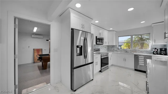 a kitchen with refrigerator and cabinets