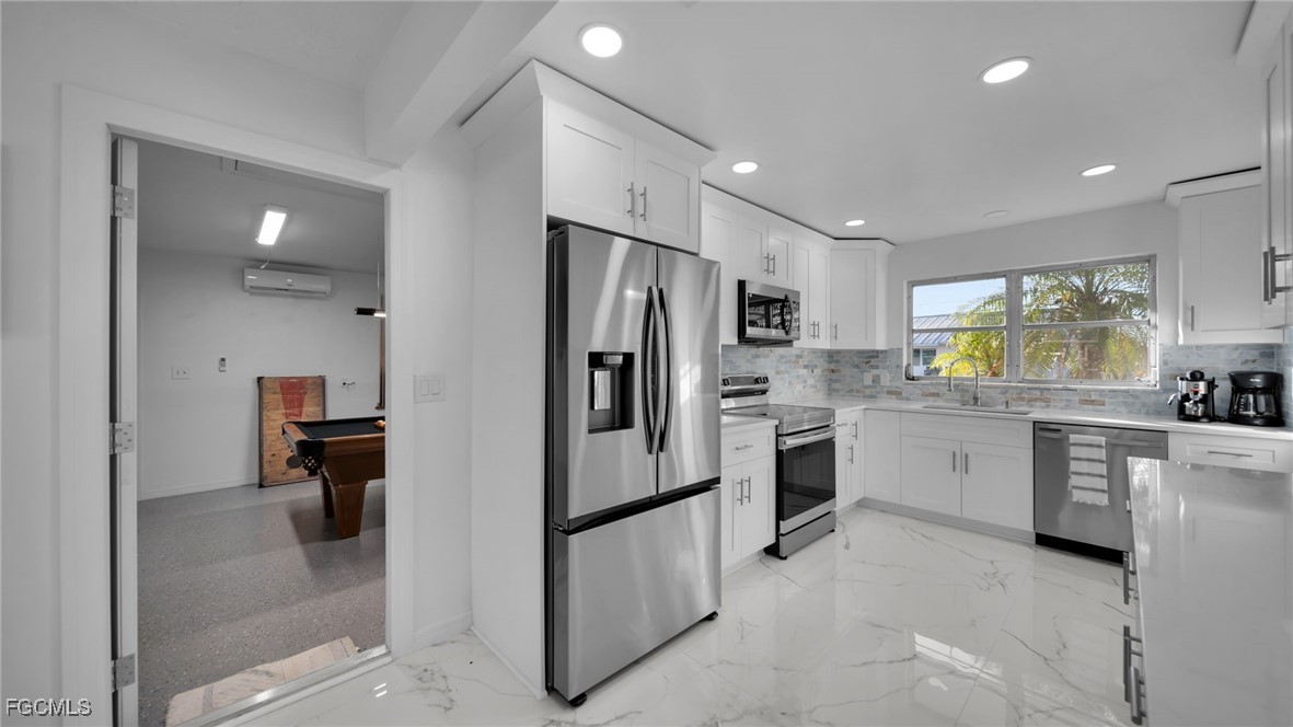 2758 Bruce Street Matlacha, FL 33993 - Photo 16 of 35 a kitchen with refrigerator and cabinets