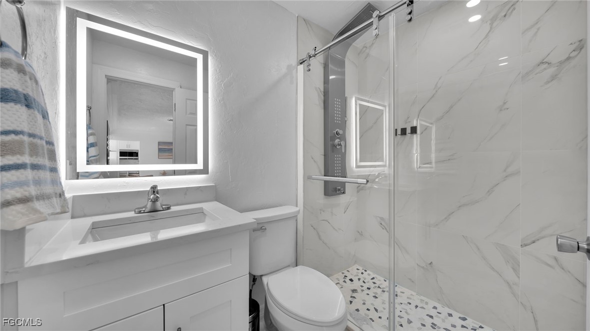 2758 Bruce Street Matlacha, FL 33993 - Photo 17 of 35 a bathroom with a sink toilet and shower