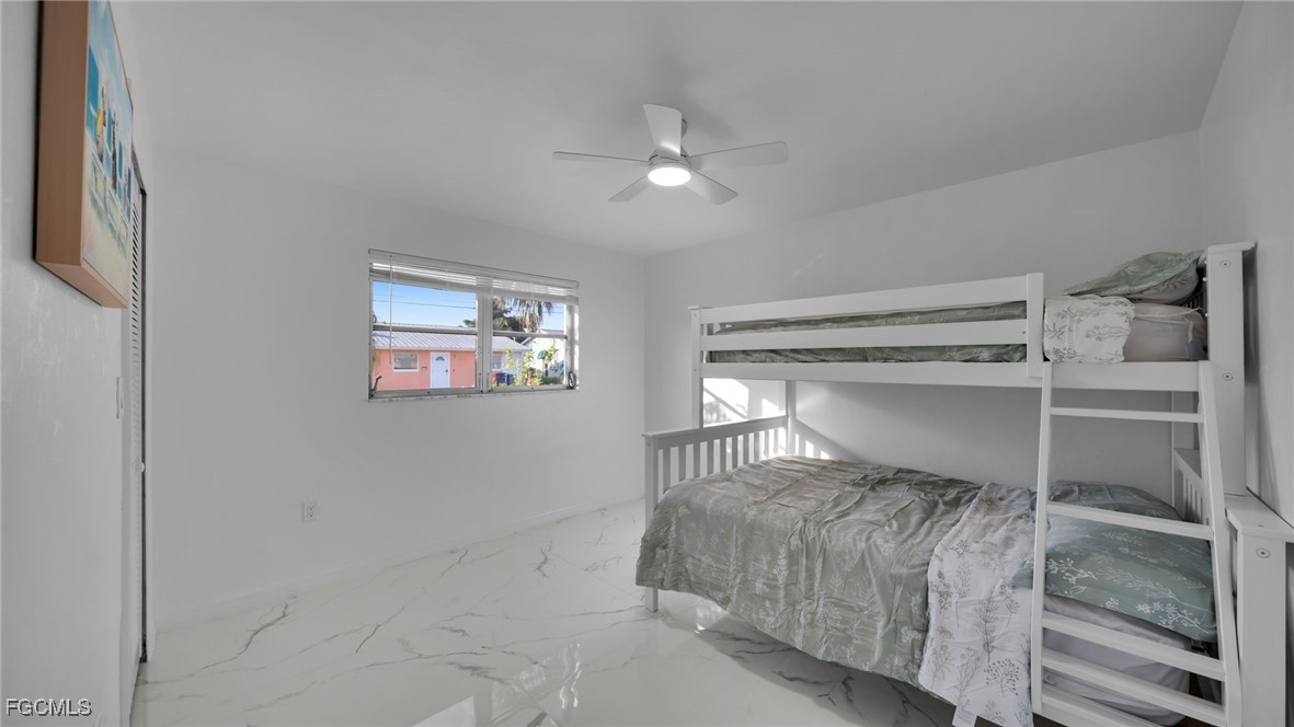 2758 Bruce Street Matlacha, FL 33993 - Photo 20 of 35 a bedroom with a bed and a window