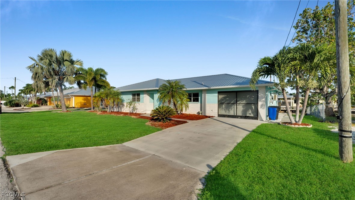 2758 Bruce Street Matlacha, FL 33993 - Photo 2 of 35 a front view of a house with a yard and porch