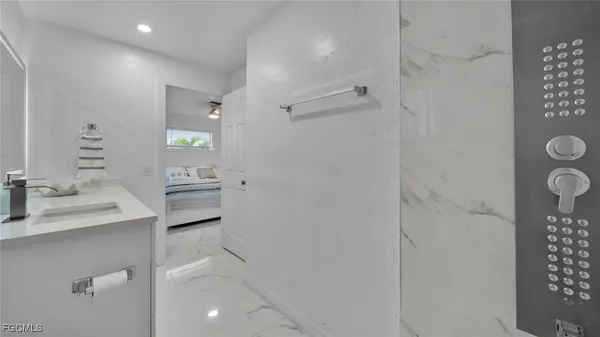 a bathroom with a sink toilet and shower