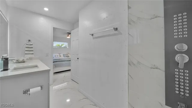 a bathroom with a sink toilet and shower