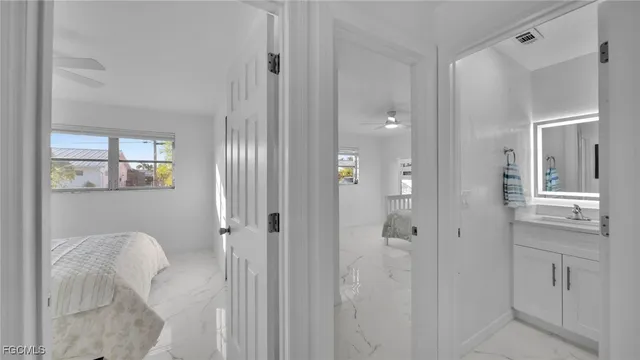 a bathroom with a granite countertop sink a toilet and shower