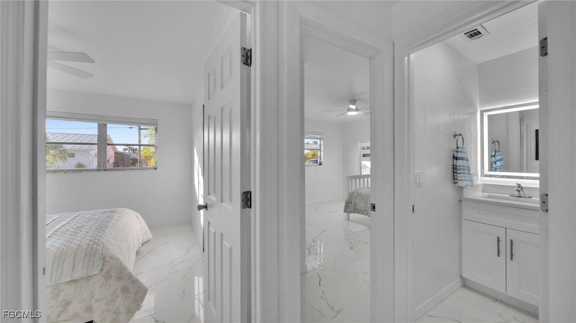 2758 Bruce Street Matlacha, FL 33993 - Photo 24 of 35 a bathroom with a granite countertop sink a toilet and shower