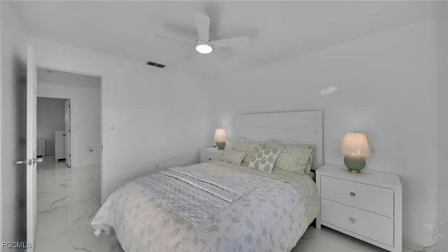 a bedroom with a bed and a lamp