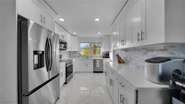 a kitchen with refrigerator and cabinets