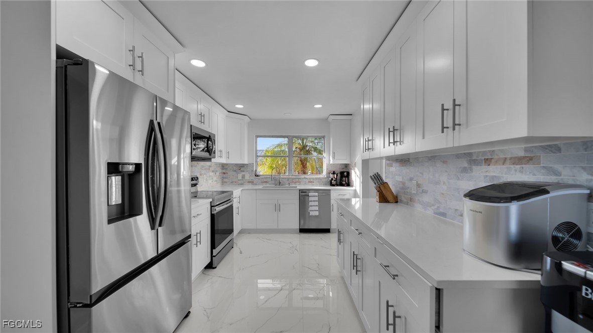 2758 Bruce Street Matlacha, FL 33993 - Photo 27 of 35 a kitchen with refrigerator and cabinets