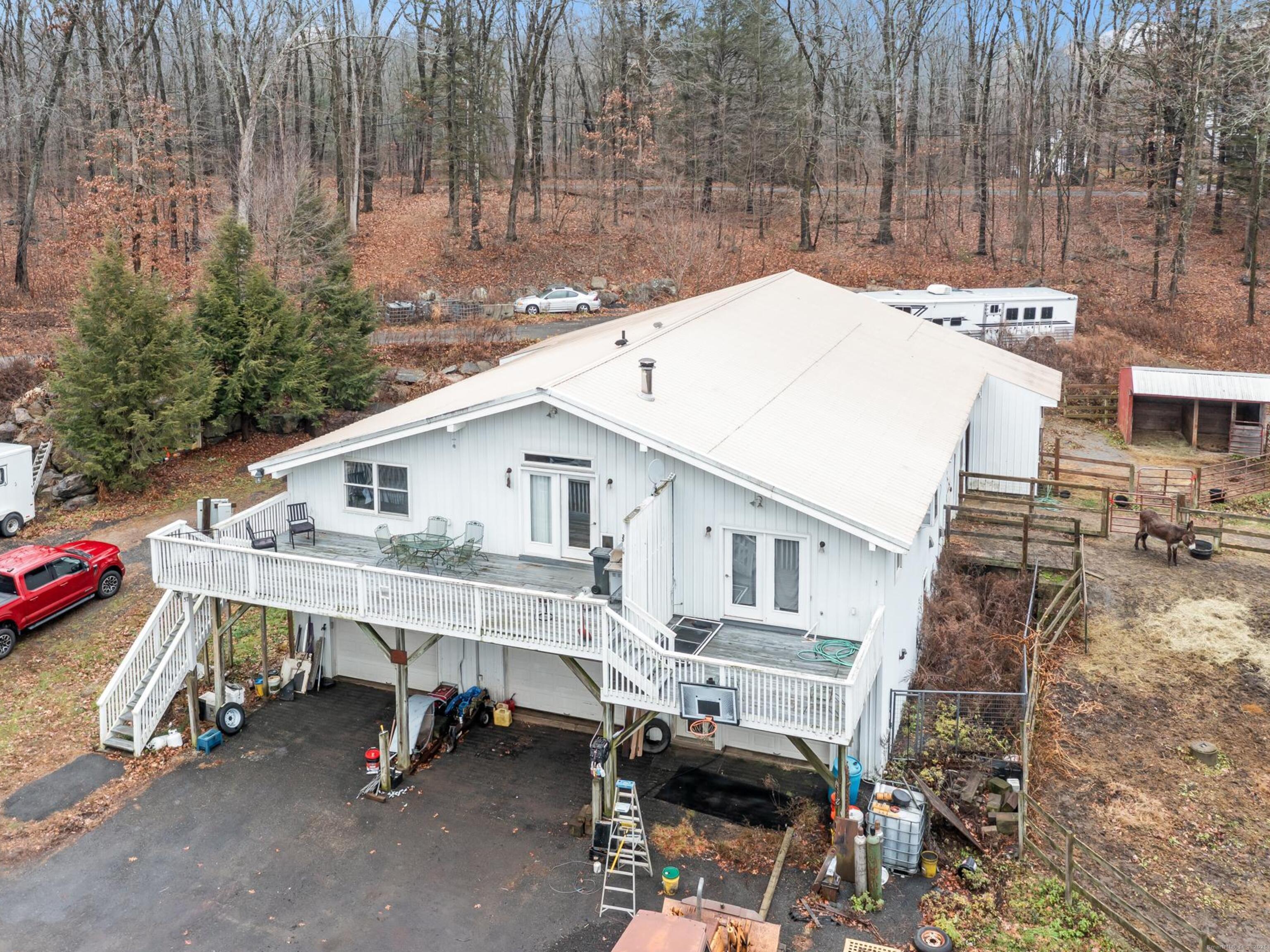 a view of a patio with table and chairs with wooden fence and plants