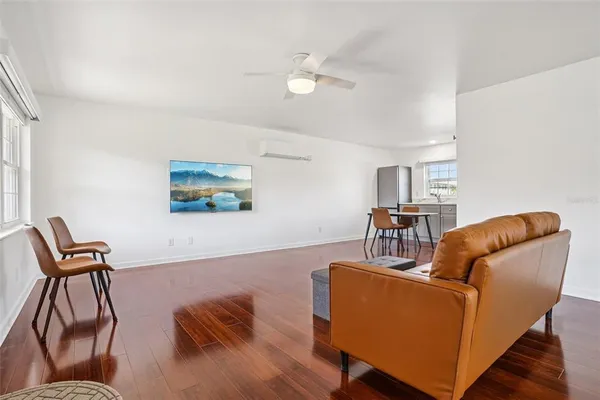a living room with furniture and a wooden floor