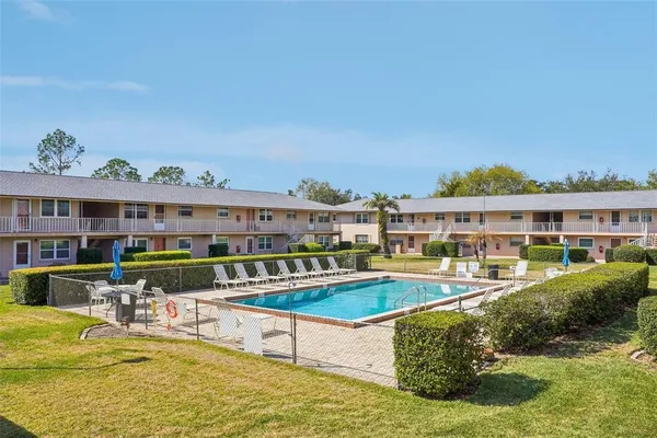 a front view of a house with a yard and potted plants