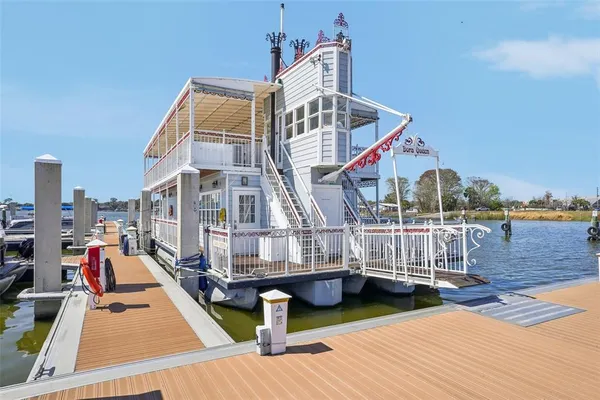 a view of a dining room with furniture a rug and wooden floor
