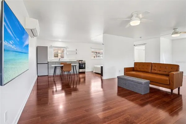a living room with furniture and wooden floor