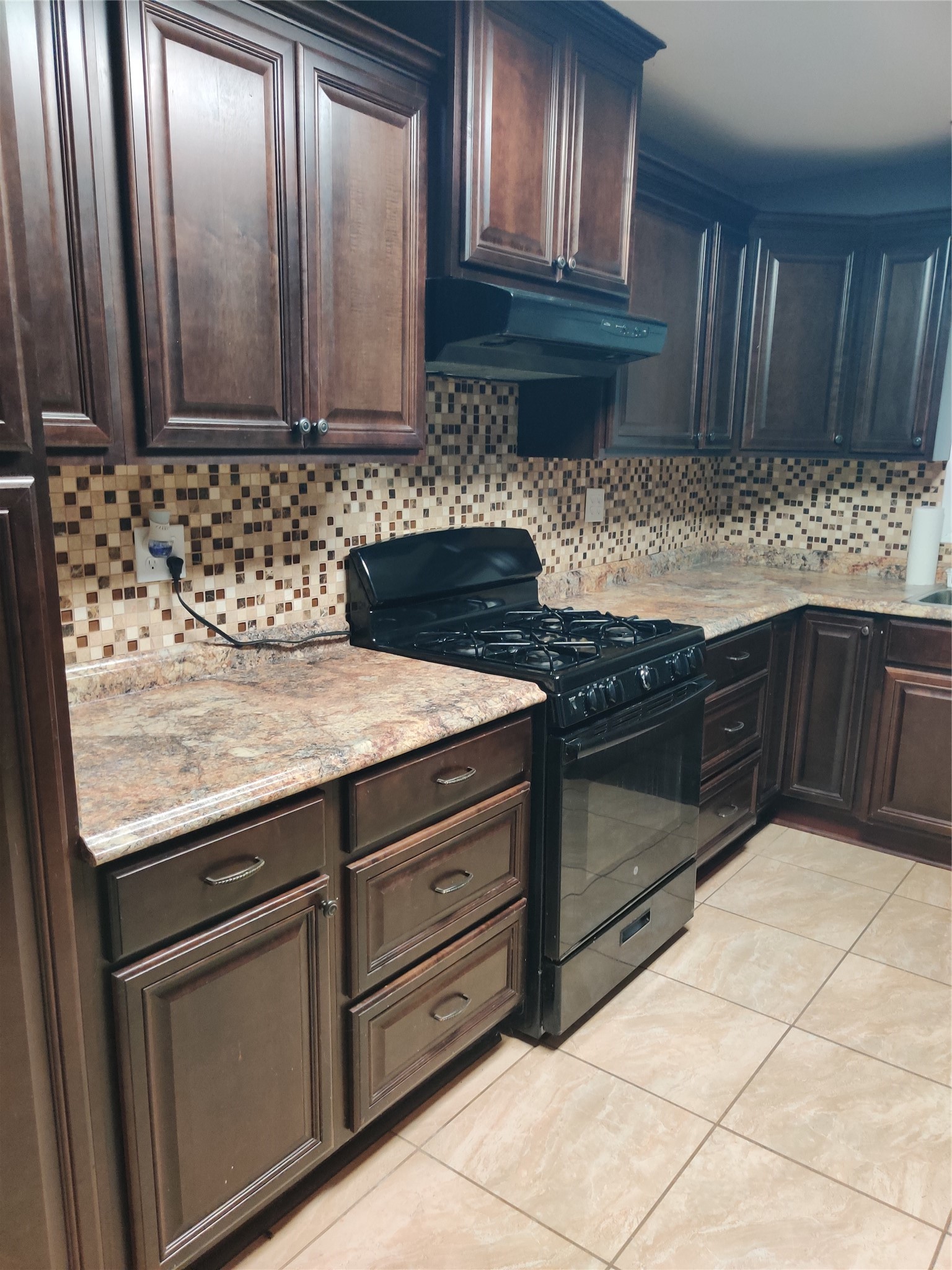 3314 Fern Street Pasadena, TX 77503 - Photo 3 of 14 a kitchen with granite countertop wooden cabinets and a sink