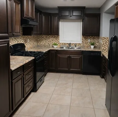 a kitchen with granite countertop a sink stove and cabinets