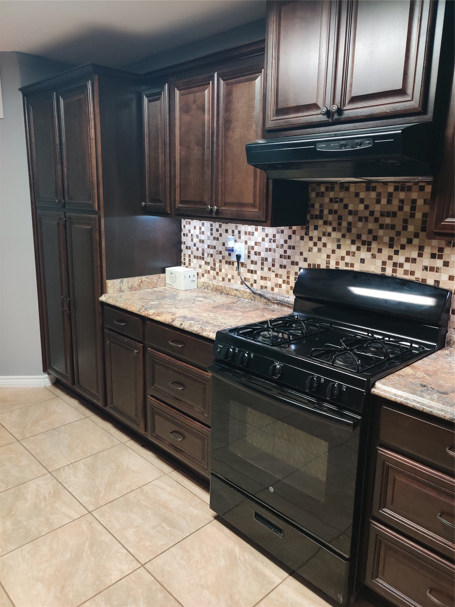 3314 Fern Street Pasadena, TX 77503 - Photo 4 of 14 a kitchen with granite countertop a stove and a refrigerator