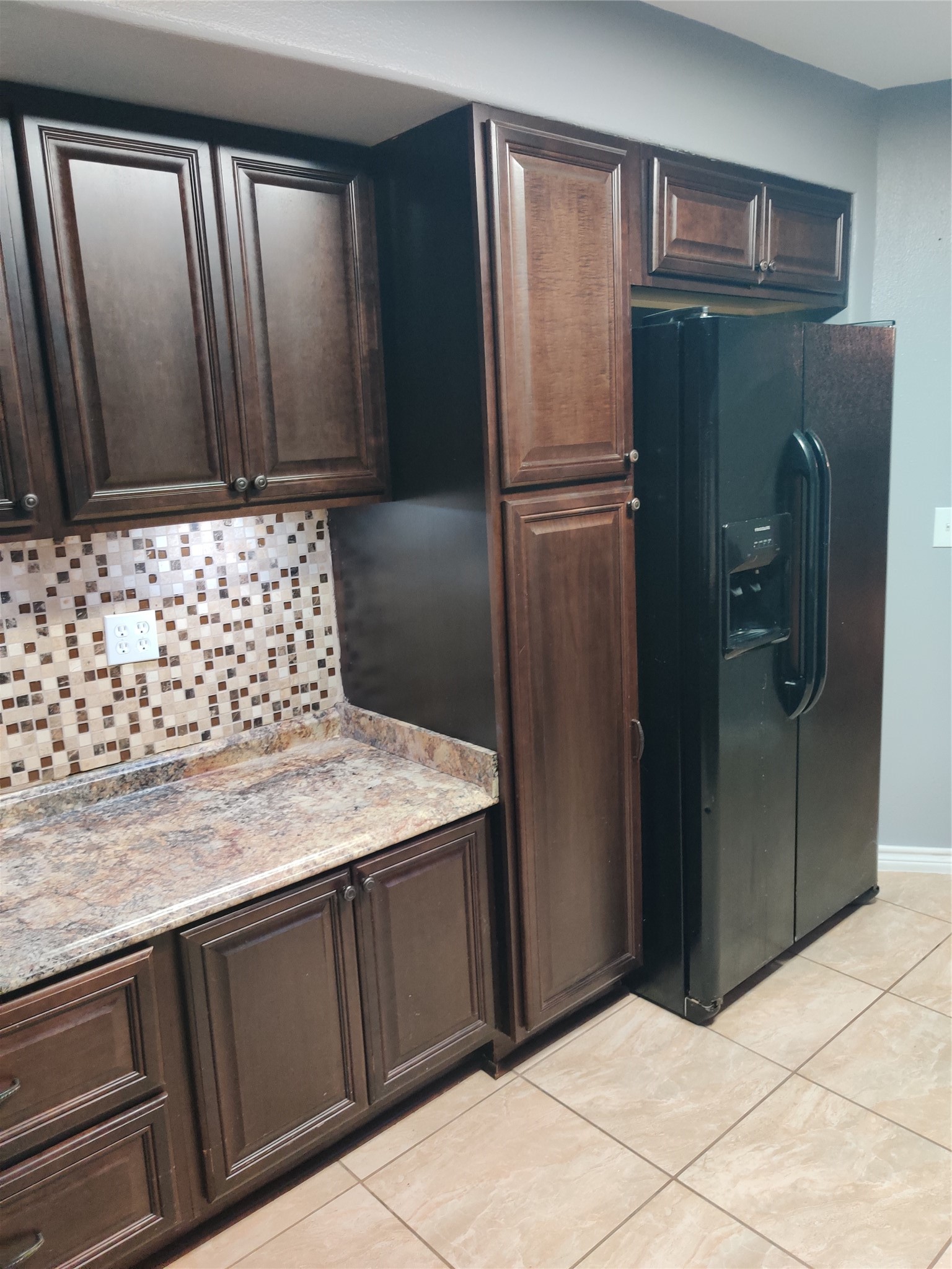 3314 Fern Street Pasadena, TX 77503 - Photo 5 of 14 a bathroom with a granite countertop sink and a refrigerator