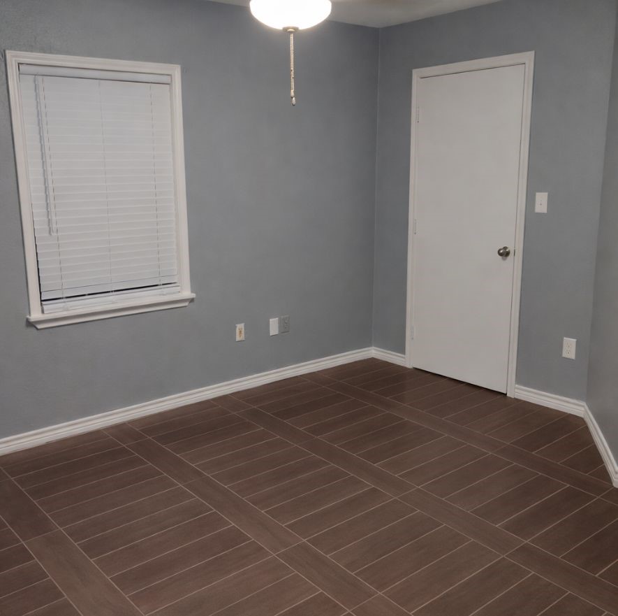 3314 Fern Street Pasadena, TX 77503 - Photo 10 of 14 an empty room with wooden floor and windows