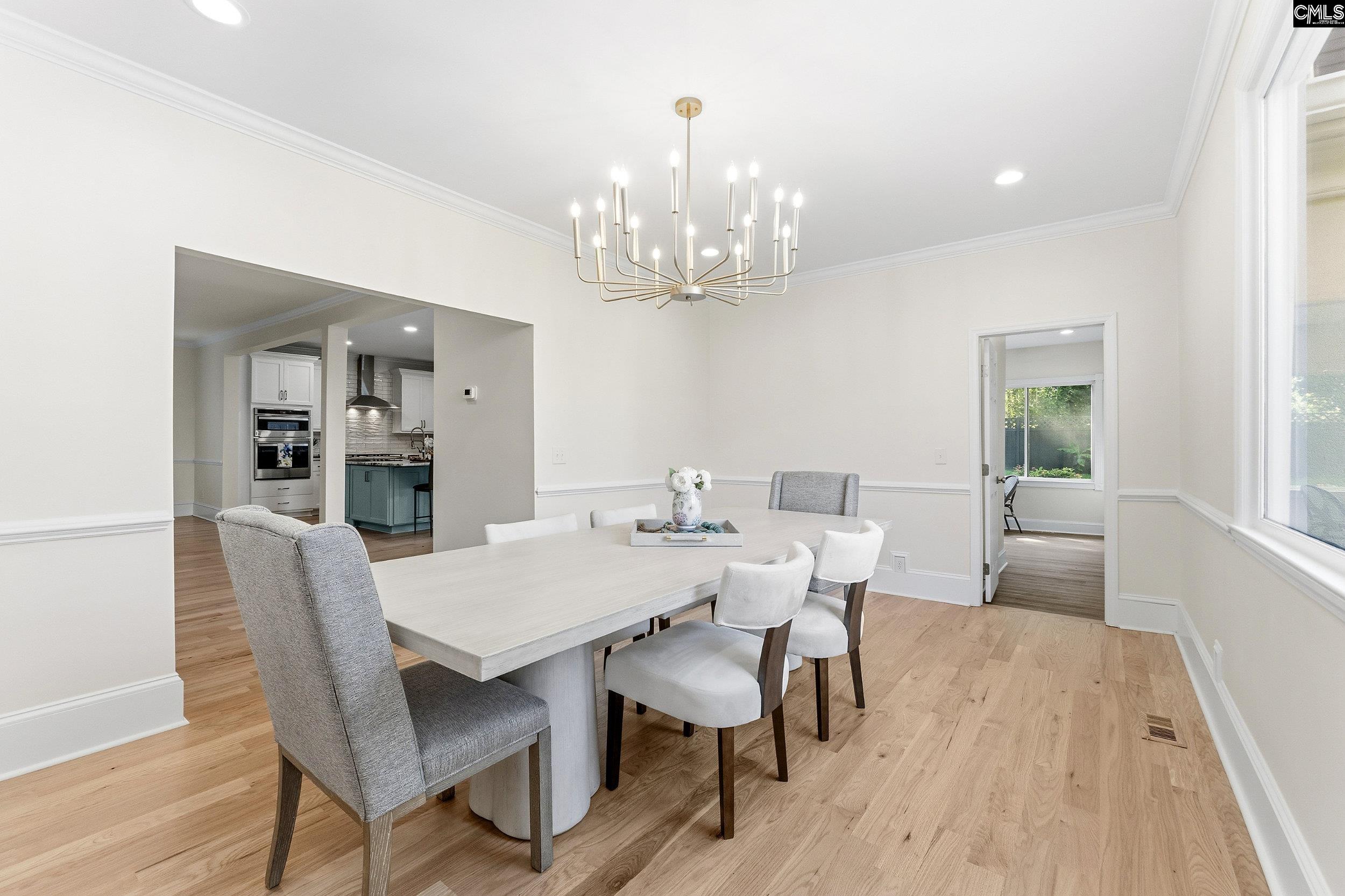 121 Silver Lake Road East Columbia, SC 29223 - Photo 19 of 57 a view of a dining room with furniture wooden floor and chandelier