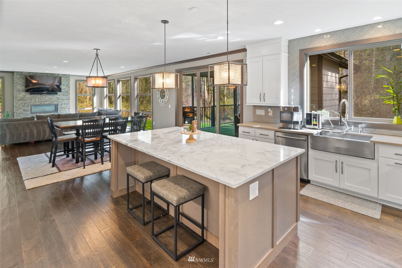 19129 43rd Avenue Southeast Bothell, WA 98012 - Photo 17 of 34 a kitchen with granite countertop a stove a sink a dining table and chairs with wooden floor