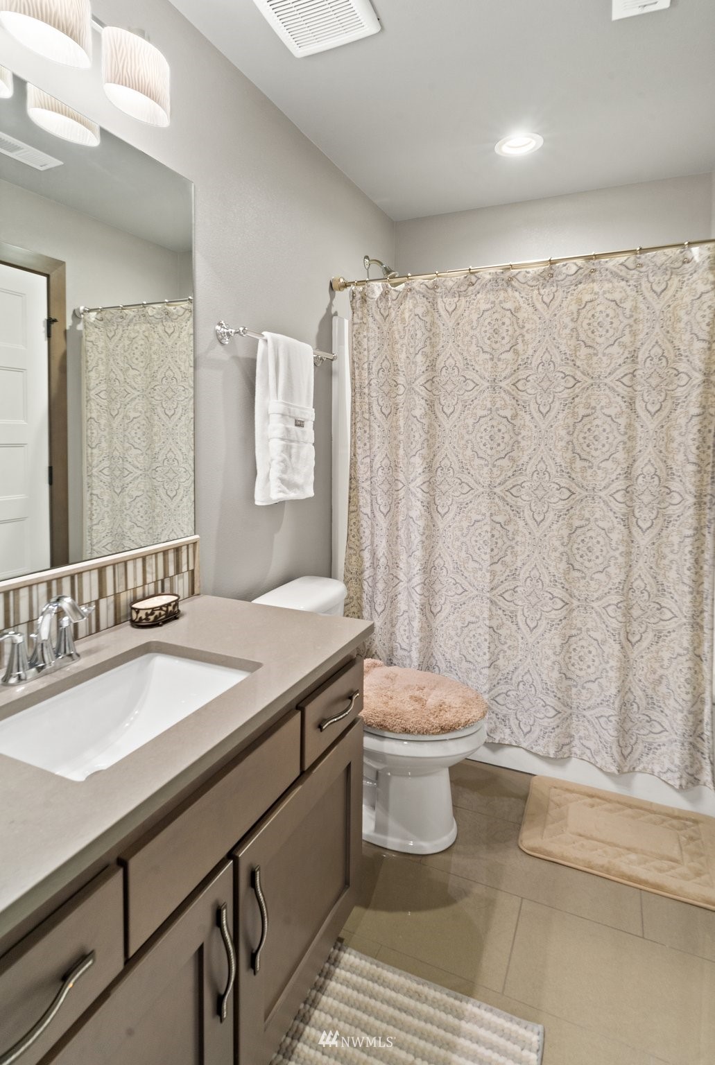 19129 43rd Avenue Southeast Bothell, WA 98012 - Photo 25 of 34 a bathroom with a sink a toilet and shower