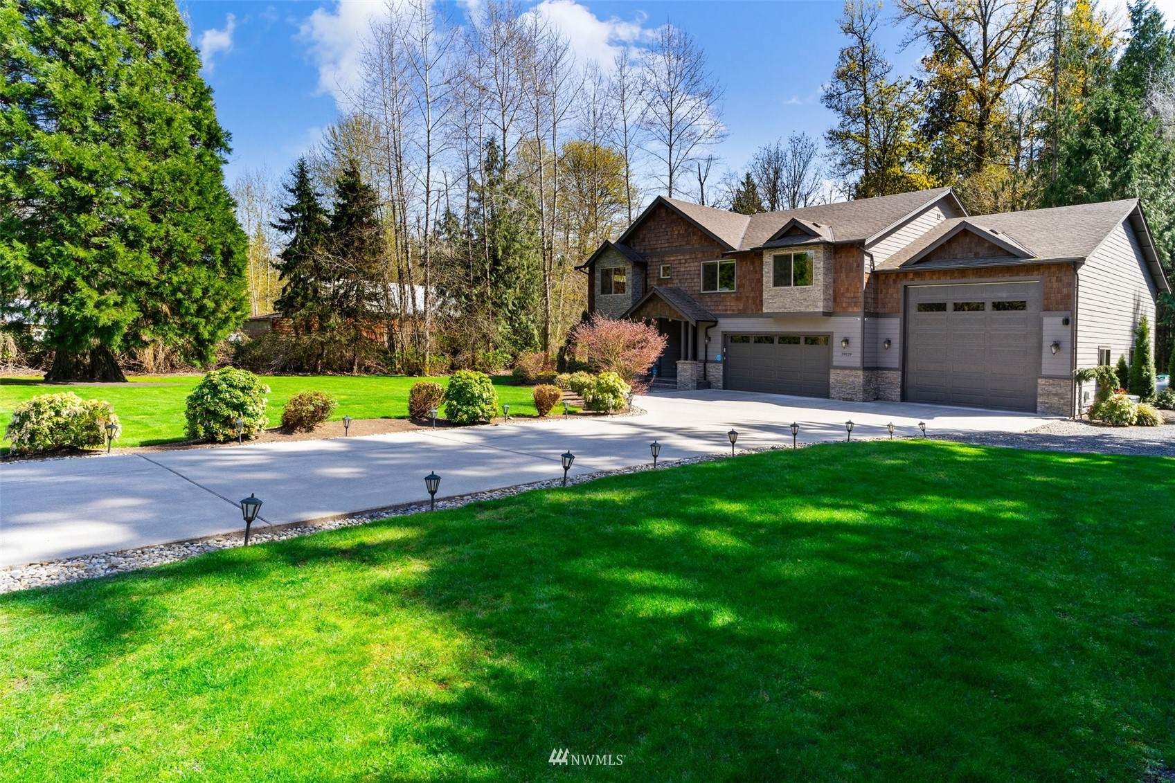 19129 43rd Avenue Southeast Bothell, WA 98012 - Photo 5 of 34 a front view of a house with a yard and green space