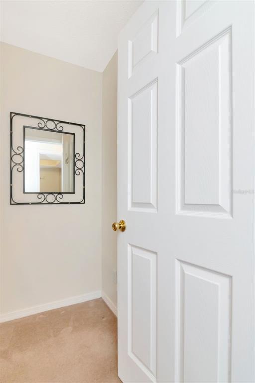 2281 Shelly Drive, Unit D Palm Harbor, FL 34684 - Photo 26 of 53 a view of a small space with wooden floor and a mirror