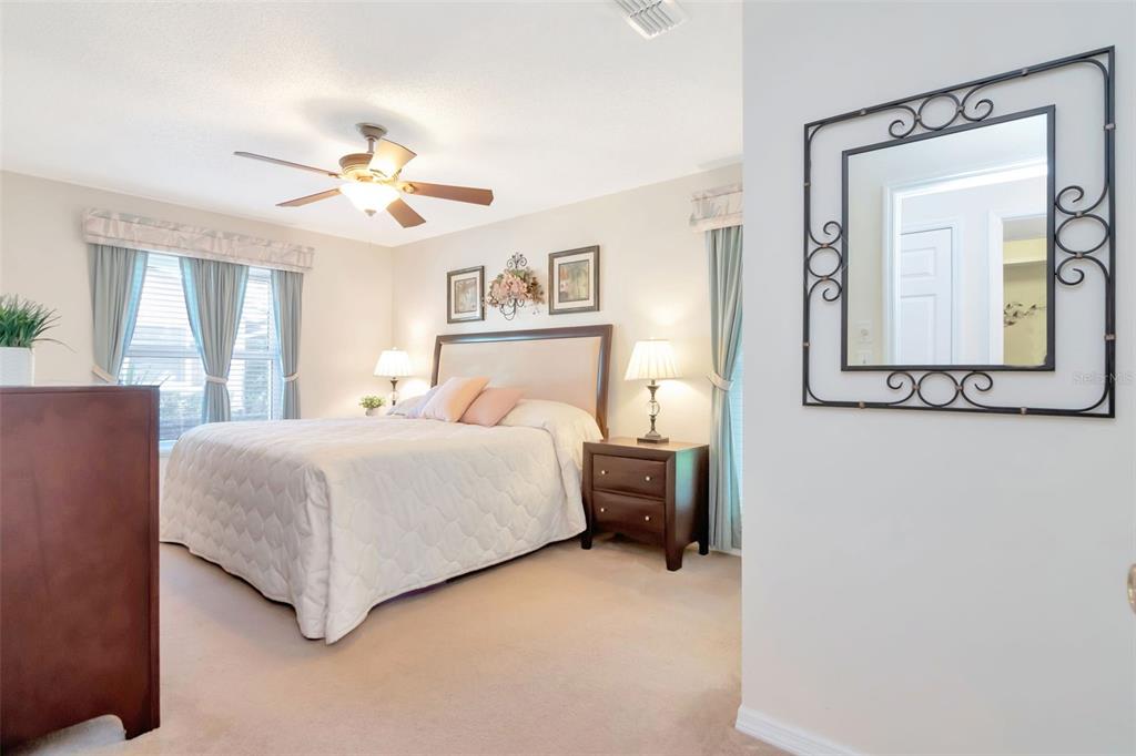 2281 Shelly Drive, Unit D Palm Harbor, FL 34684 - Photo 27 of 53 a bedroom with a bed and a chandelier