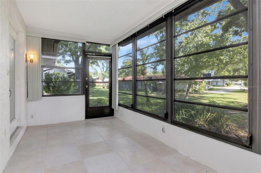 2281 Shelly Drive, Unit D Palm Harbor, FL 34684 - Photo 7 of 53 a view of a porch with a floor to ceiling window