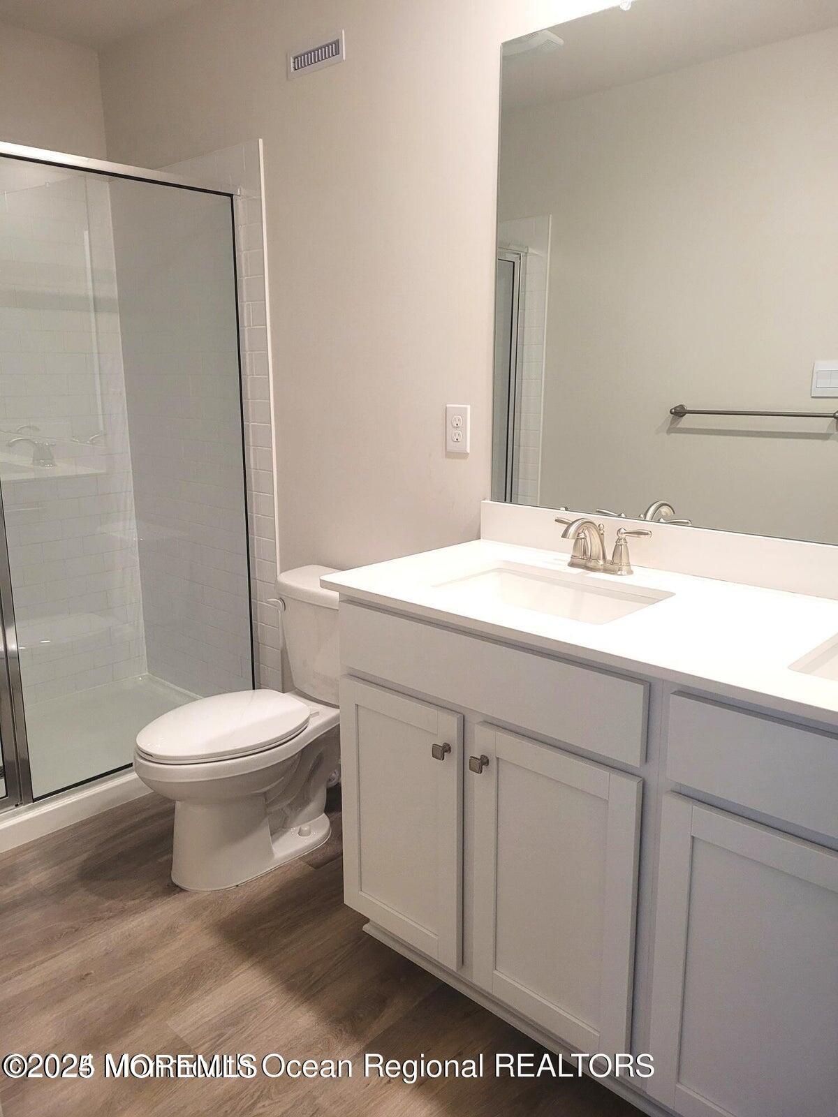 73 Nelsons Way Westampton, NJ 08060 - Photo 15 of 18 a bathroom with a sink a toilet a mirror and shower