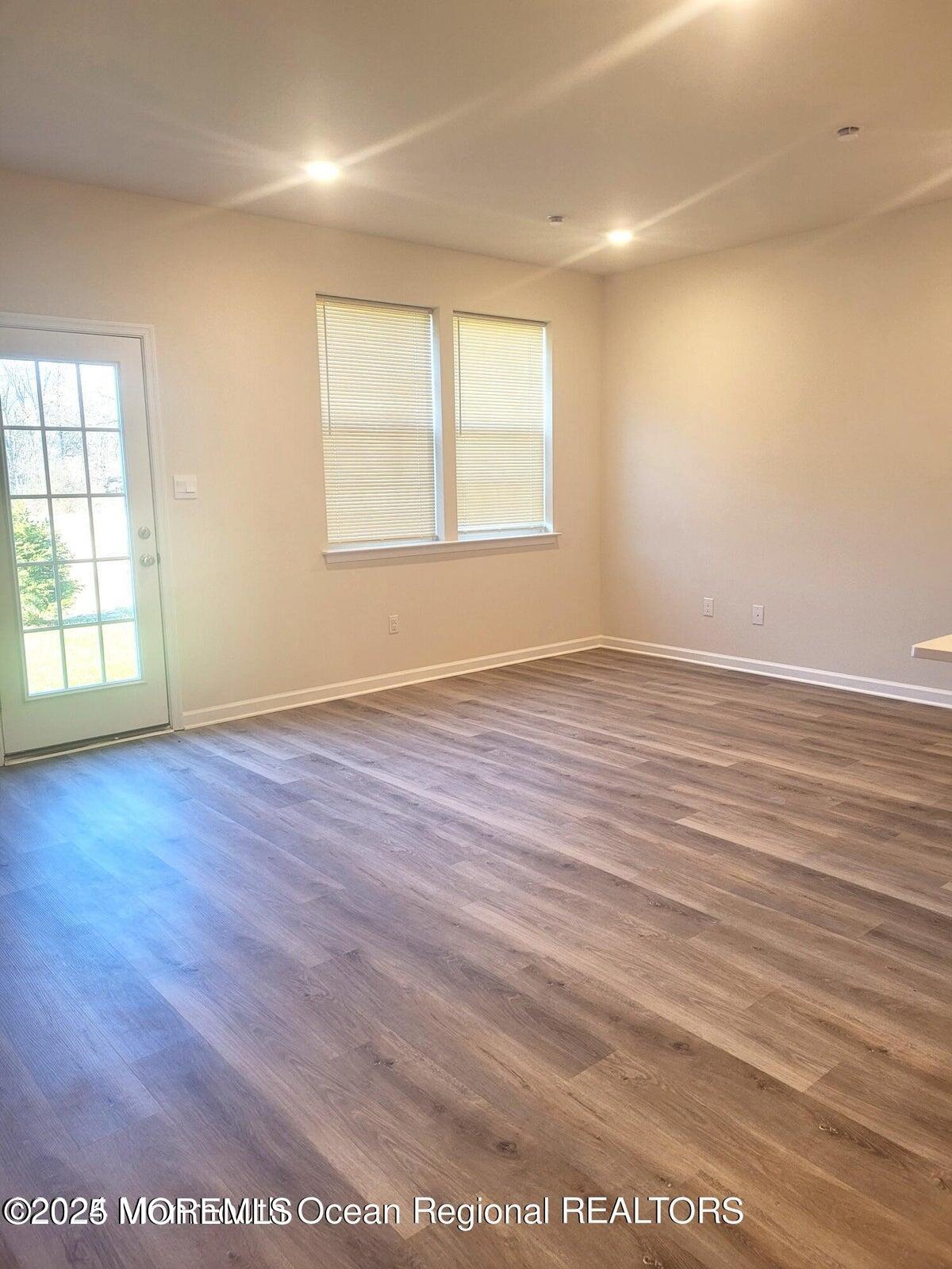 73 Nelsons Way Westampton, NJ 08060 - Photo 4 of 18 an empty room with wooden floor and windows