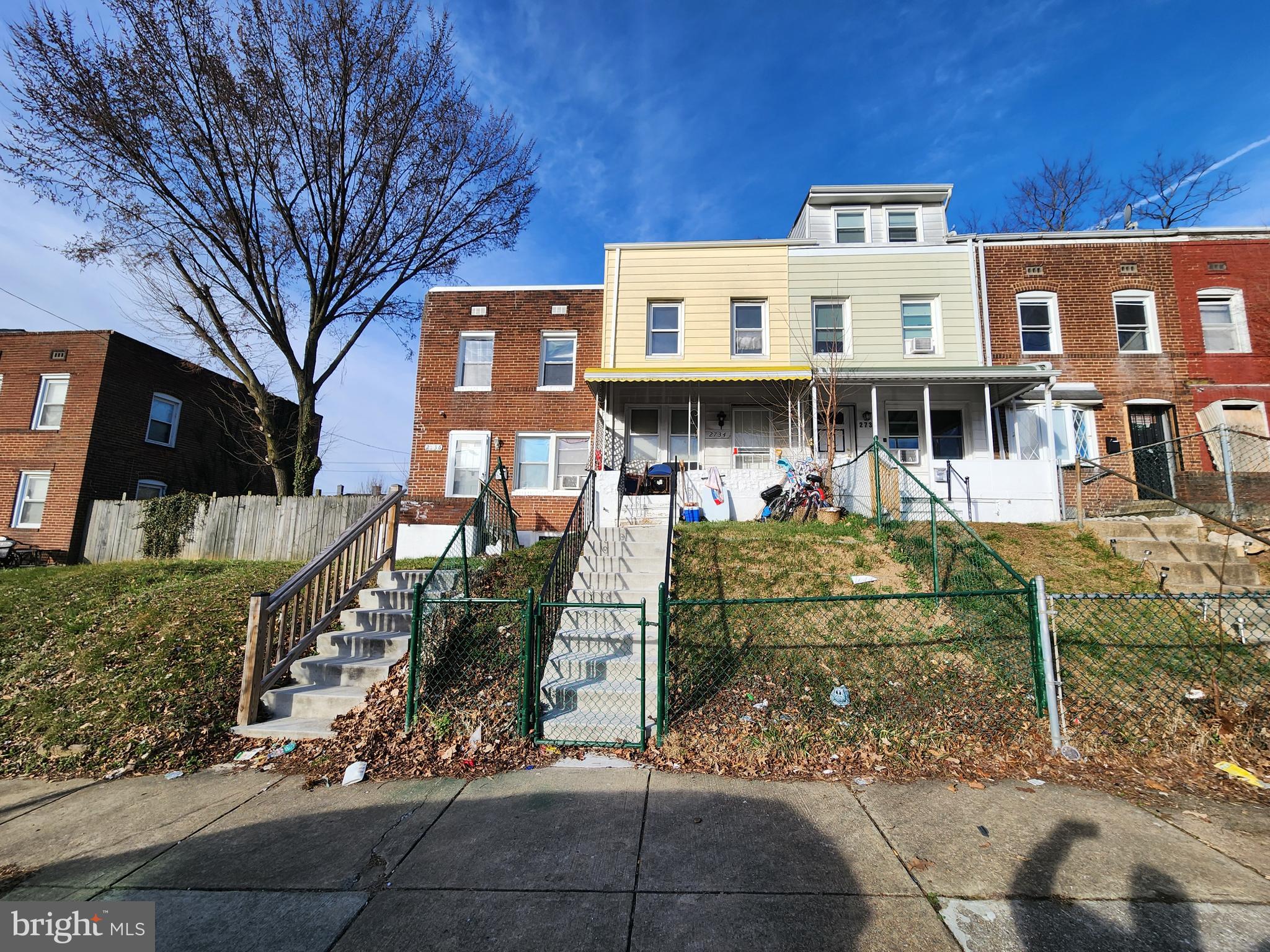2734 Bookert Drive Baltimore, MD 21225 - Photo 2 of 3 a front view of a residential apartment building with a yard
