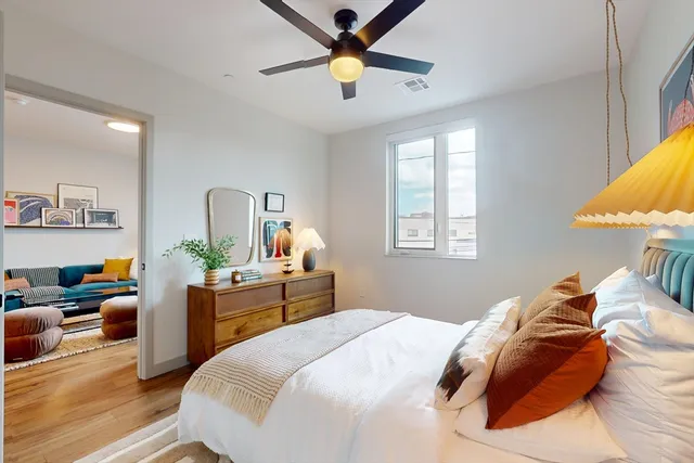 a bedroom with a bed and a chandelier