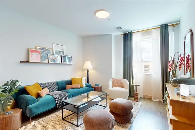 a living room with furniture and a lamp