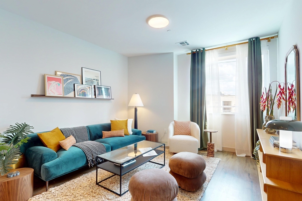 80 Rugg Road, Unit 1301 Boston, MA 02134 - Photo 14 of 20 a living room with furniture and a lamp