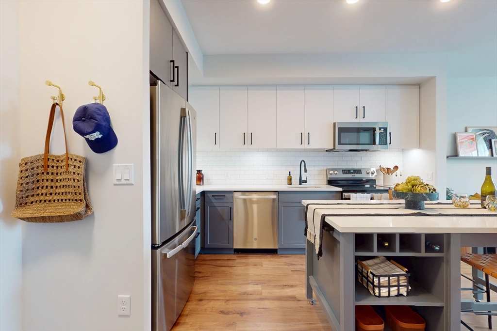 80 Rugg Road, Unit 1301 Boston, MA 02134 - Photo 15 of 20 a kitchen with a sink a stove and refrigerator