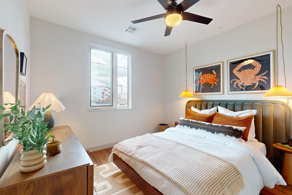 80 Rugg Road, Unit 1301 Boston, MA 02134 - Photo 5 of 20 a bedroom with bed and a chandelier