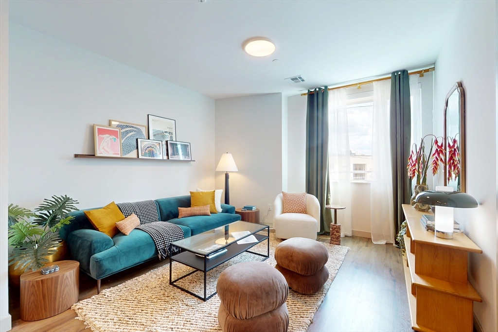 80 Rugg Road, Unit 1301 Boston, MA 02134 - Photo 7 of 20 a living room with furniture and painting on the wall
