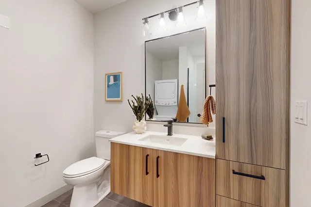 a bathroom with a sink a toilet and mirror