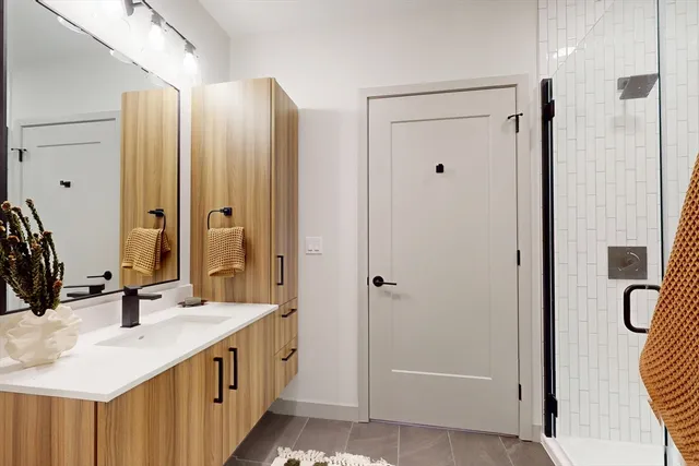 a bathroom with a double vanity sink and mirror