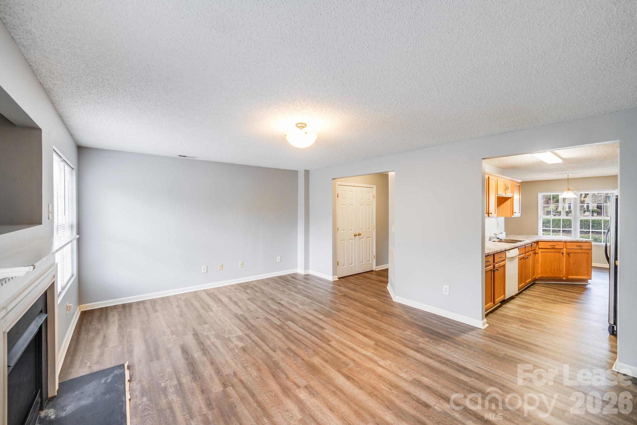 3260 Barons Court Road Charlotte, NC 28213 - Photo 11 of 25 a view of an empty room with wooden floor and a window