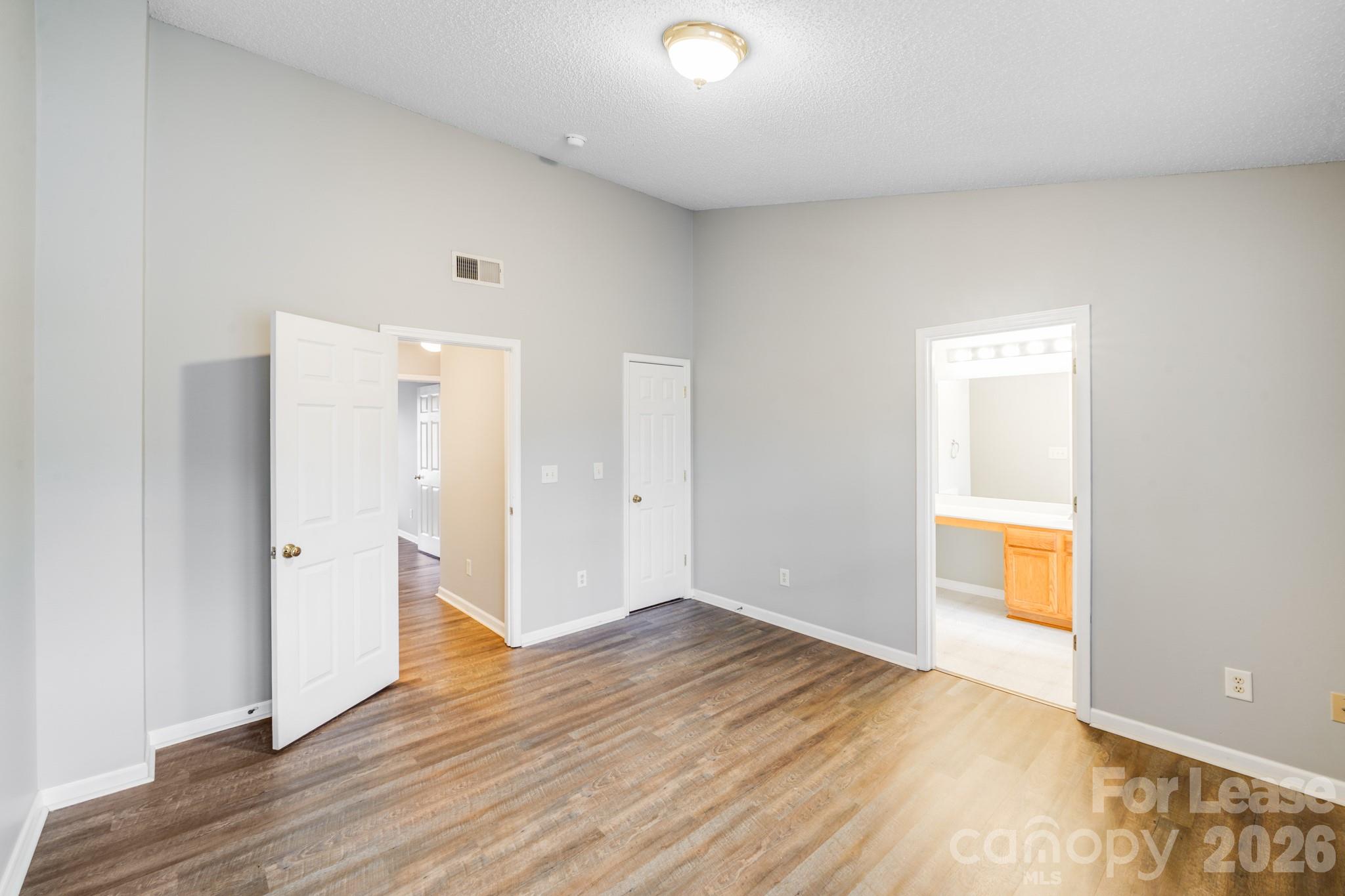 3260 Barons Court Road Charlotte, NC 28213 - Photo 15 of 25 a view of an empty room with wooden floor and a window