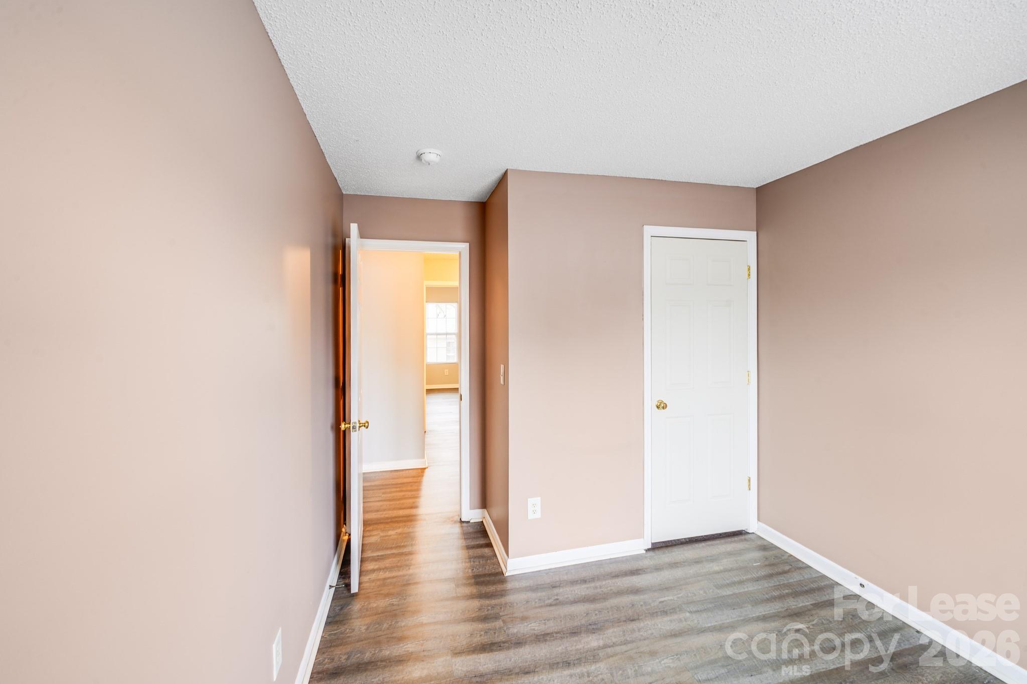 3260 Barons Court Road Charlotte, NC 28213 - Photo 17 of 25 a view of an empty room with wooden floor