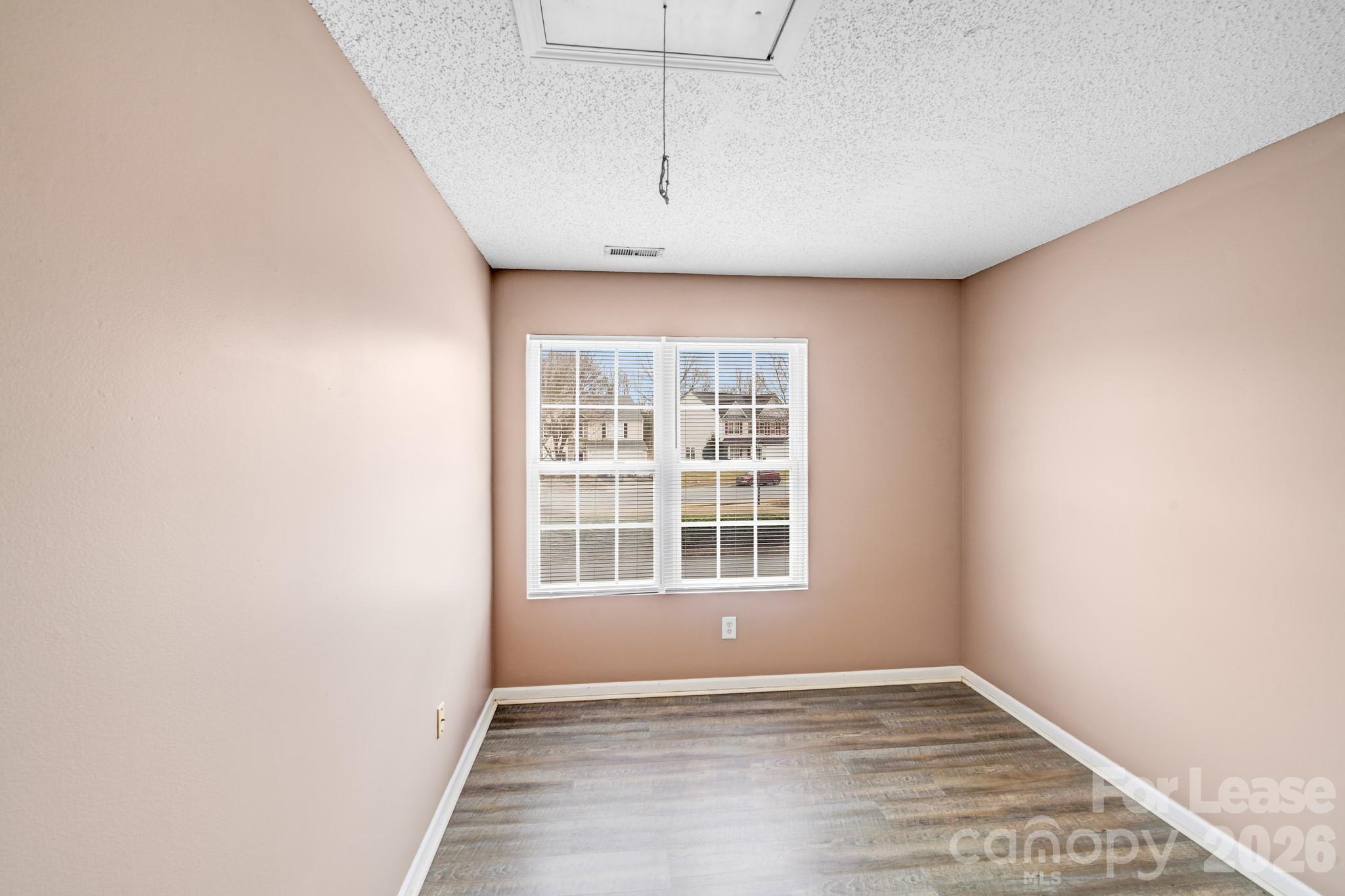 3260 Barons Court Road Charlotte, NC 28213 - Photo 18 of 25 an empty room with wooden floor and windows