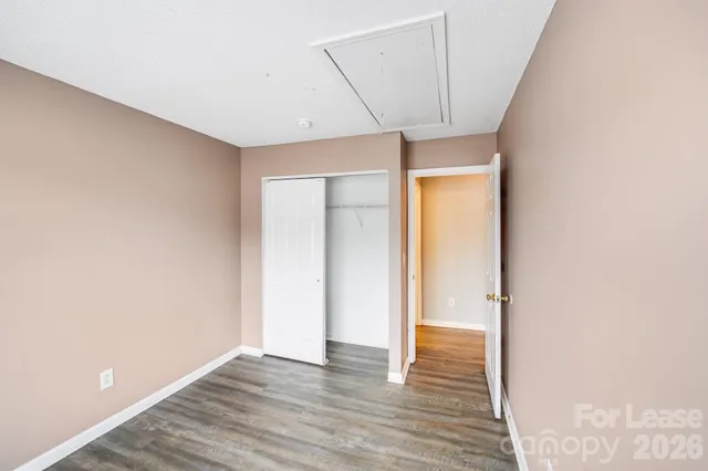 a view of hallway with wooden floor