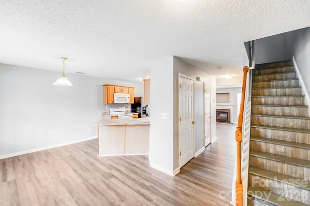 a view of kitchen with sink and wooden floor