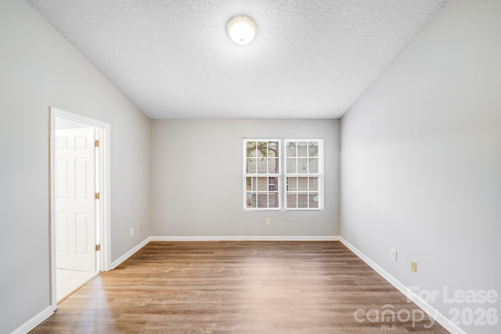 3260 Barons Court Road Charlotte, NC 28213 - Photo 5 of 25 an empty room with wooden floor and windows