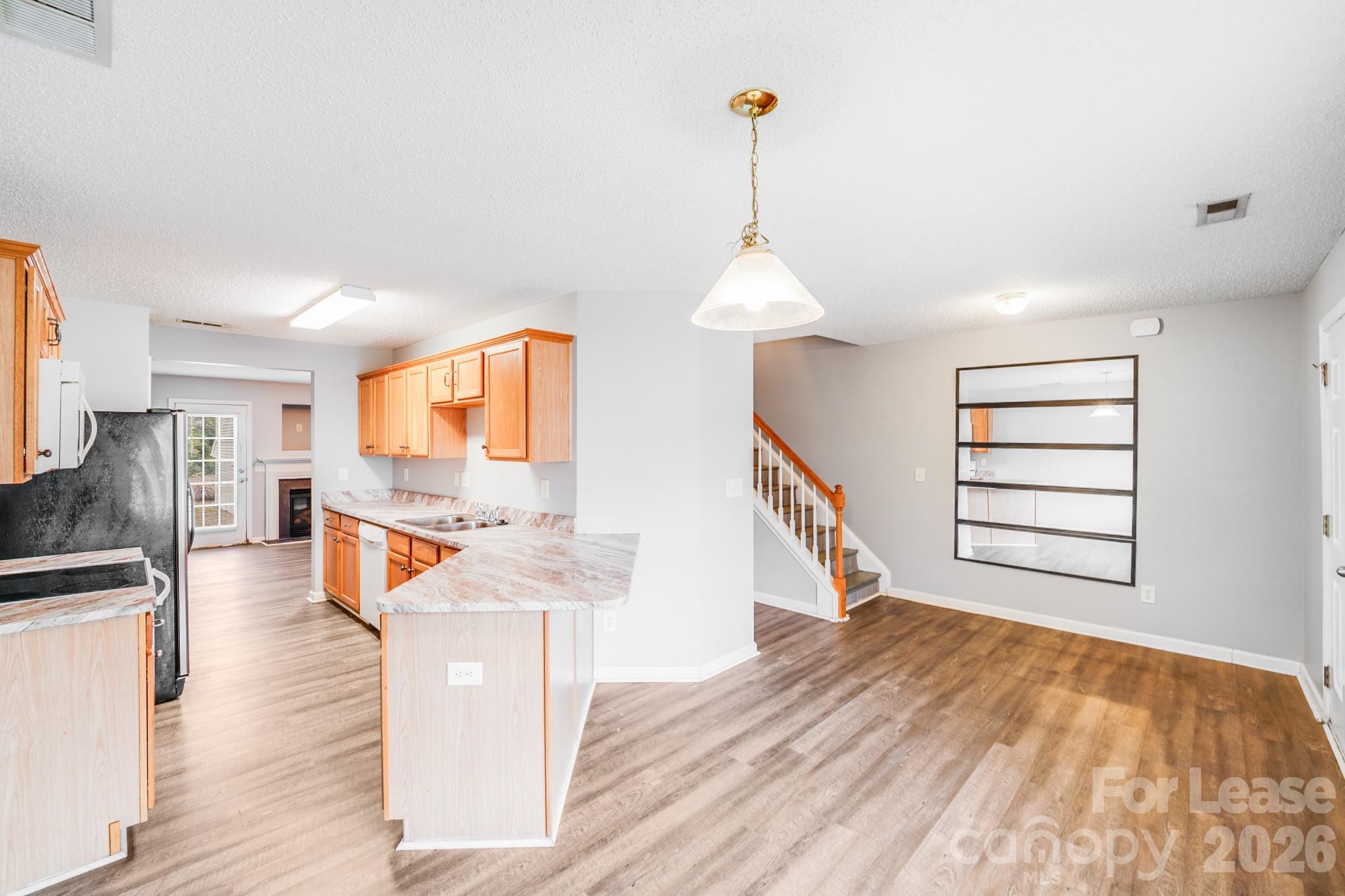 3260 Barons Court Road Charlotte, NC 28213 - Photo 10 of 25 a view of a kitchen with furniture and wooden floor