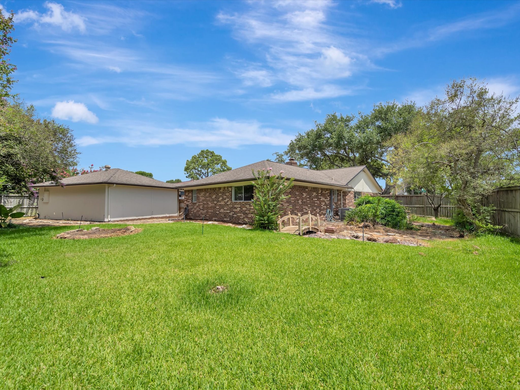 10340 Rocky Hollow Road La Porte, TX 77571 - Photo 36 of 38 Spacious backyard featuring landscaping and a built-in sprinkler system.